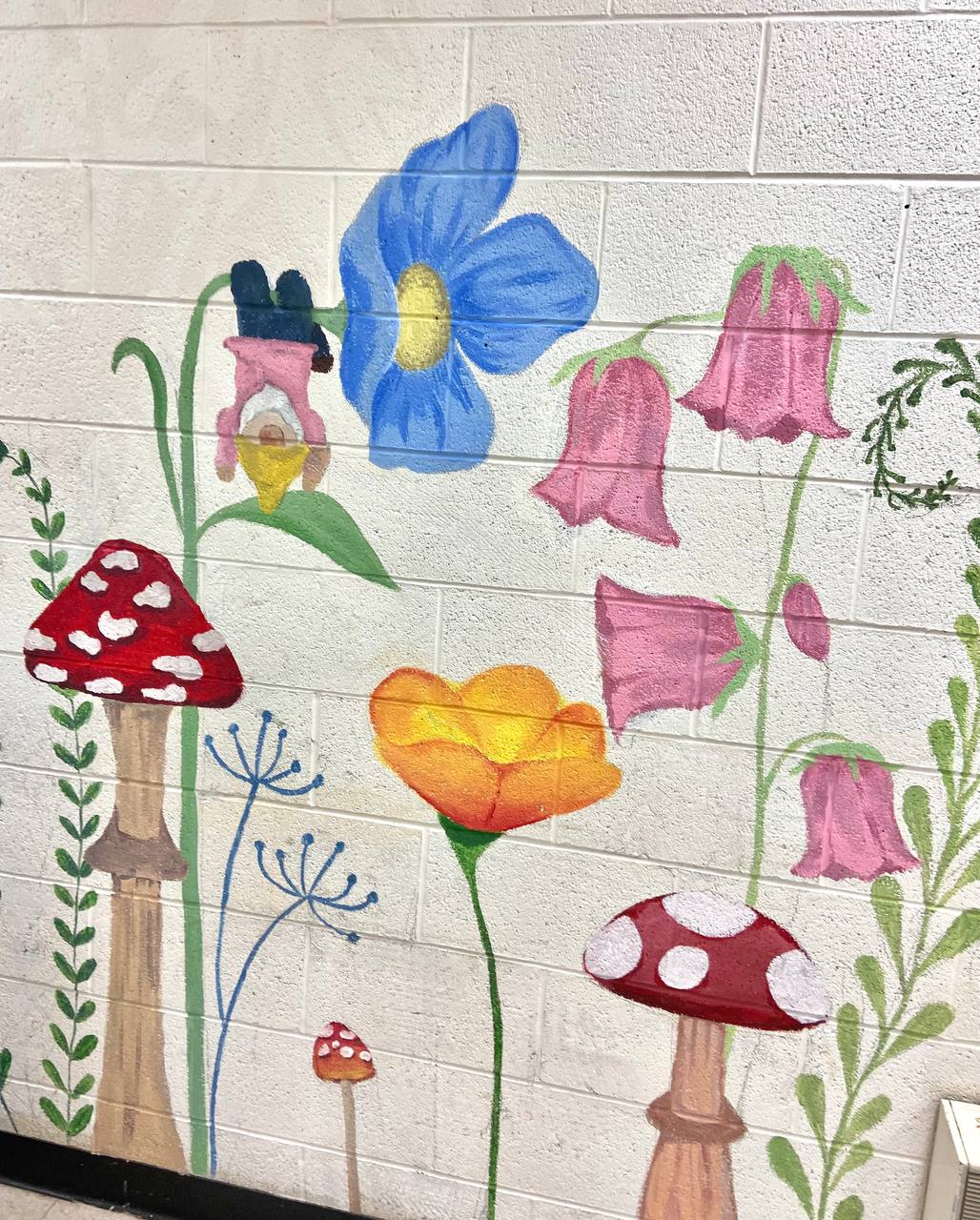 Whimsical garden mural with blue flowers and mushrooms