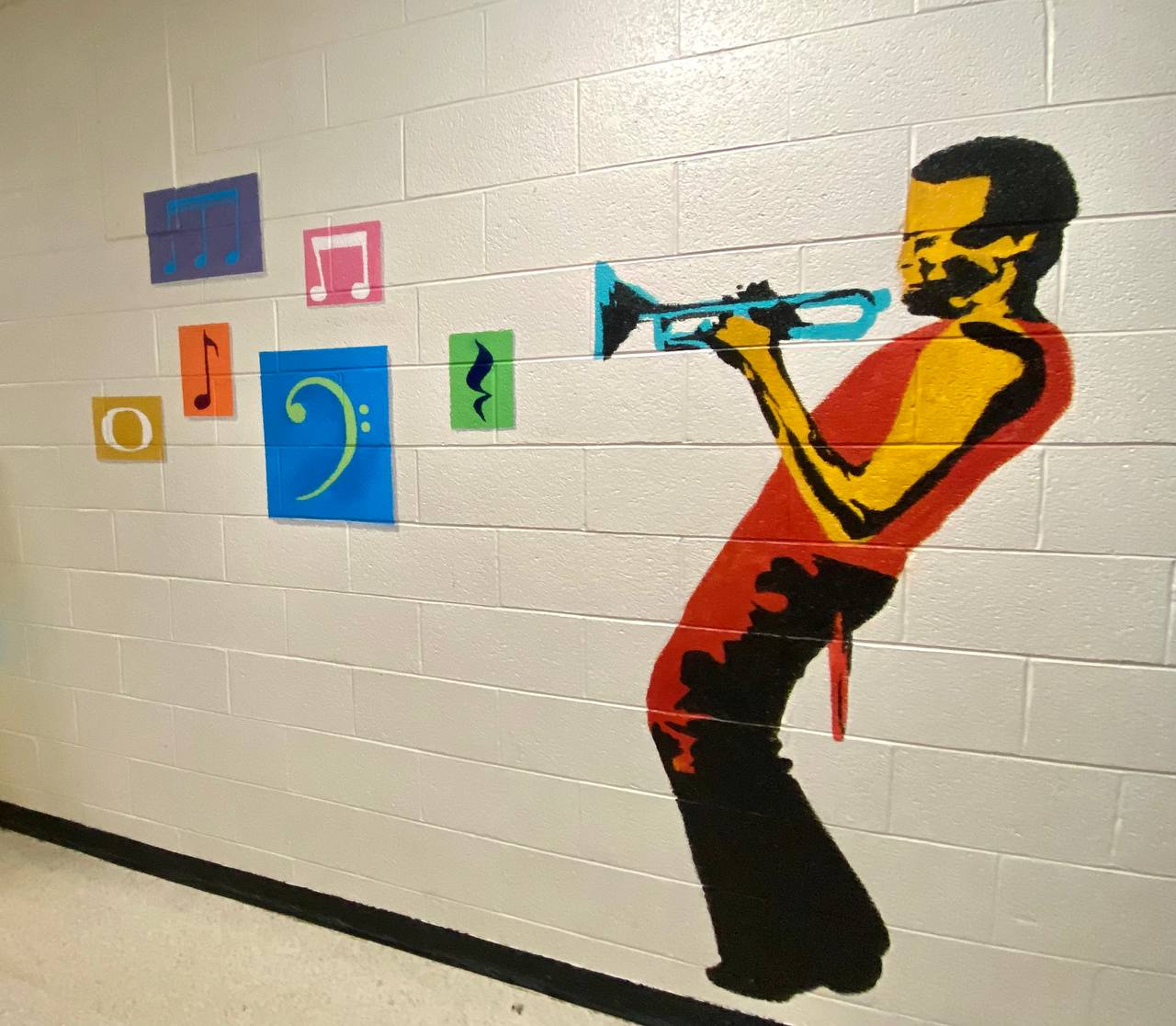 Jazz trumpet player mural with colorful musical notes